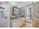 Bathroom vanity with marble countertop, custom cabinetry, and a decorative mirror provides a luxurious space at 3030 Marshall Blvd, Sullivans Island, SC 29482
