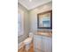 Bathroom featuring granite countertop, framed mirror, and white cabinets at 3030 Marshall Blvd, Sullivans Island, SC 29482