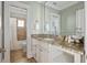 Bathroom featuring granite counters, double sinks, and decorative cabinets at 3030 Marshall Blvd, Sullivans Island, SC 29482