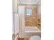 Cozy bathroom with decorative tile, shower, and a window at 3030 Marshall Blvd, Sullivans Island, SC 29482