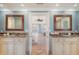 Elegant double vanity with marble countertops and framed mirrors offers a serene view to the primary bedroom at 3030 Marshall Blvd, Sullivans Island, SC 29482