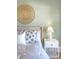 Cozy bedroom featuring a decorative wall hanging, a bedside table with lamp, and accent pillows at 3030 Marshall Blvd, Sullivans Island, SC 29482