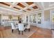 Charming dining room with seating for six, rustic wood ceiling, and an open view to the kitchen at 3030 Marshall Blvd, Sullivans Island, SC 29482