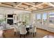 Bright dining space featuring a rustic coffered ceiling, hardwood floors, and an open living space design at 3030 Marshall Blvd, Sullivans Island, SC 29482