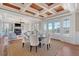 Elegant dining room area with a rustic wood ceiling, hardwood floors, and lots of natural light at 3030 Marshall Blvd, Sullivans Island, SC 29482