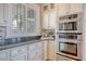 Kitchen with stainless appliances, custom cabinets, granite countertops, and double ovens at 3030 Marshall Blvd, Sullivans Island, SC 29482