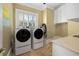 Well-lit laundry room features a modern washer and dryer set and ample storage space at 3030 Marshall Blvd, Sullivans Island, SC 29482