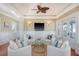 Inviting living room with white chairs, ceiling fan, and a calming coastal color palette at 3030 Marshall Blvd, Sullivans Island, SC 29482