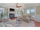 Inviting living room featuring a fireplace, built-in shelving, and an abundance of natural light at 3030 Marshall Blvd, Sullivans Island, SC 29482