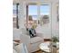 Bright living room with cozy white armchair and stunning ocean views from the sliding glass doors at 3030 Marshall Blvd, Sullivans Island, SC 29482