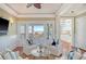 Bright living room features hardwood floors, white wainscoting, and ocean views from the large windows at 3030 Marshall Blvd, Sullivans Island, SC 29482