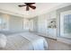 Coastal bedroom boasting custom built-ins, bright windows, and a ceiling fan at 3030 Marshall Blvd, Sullivans Island, SC 29482