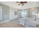 Bright Primary bedroom boasting built-in cabinets, coastal view, and a ceiling fan at 3030 Marshall Blvd, Sullivans Island, SC 29482