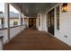 Relaxing outdoor porch features wood flooring, white pillars and railings, and rocking chairs for enjoying the view at 3030 Marshall Blvd, Sullivans Island, SC 29482