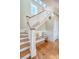 Elegant staircase features hardwood treads, white risers, and decorative details for a refined look at 3030 Marshall Blvd, Sullivans Island, SC 29482