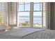 Bedroom view overlooking the ocean, featuring plantation shutters and natural light at 3030 Marshall Blvd, Sullivans Island, SC 29482