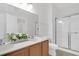 Well-lit bathroom with a double vanity, toilet, and glass enclosed shower at 3049 Park West Blvd, Mount Pleasant, SC 29466