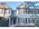 Inviting townhome exterior with neutral siding, black shutters, and well-maintained landscaping at 3049 Park West Blvd, Mount Pleasant, SC 29466