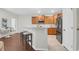 Stylish kitchen with stainless steel appliances, wood cabinets, breakfast bar, and a mix of tile and wood flooring at 3049 Park West Blvd, Mount Pleasant, SC 29466