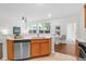Bright kitchen featuring stainless steel dishwasher, a sink, and wood cabinetry with white countertops at 3049 Park West Blvd, Mount Pleasant, SC 29466
