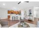 Open-concept living area with hardwood floors, bar seating, and seamless kitchen access at 3049 Park West Blvd, Mount Pleasant, SC 29466