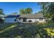 Backyard view with a patio, spacious lawn, and mature trees at 318 Hollywood Dr, Charleston, SC 29407