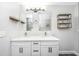 Bright bathroom with a double sink vanity, modern lighting, and a view of a shower with stylish tile at 318 Hollywood Dr, Charleston, SC 29407