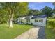 Well-maintained home with a manicured lawn and mature trees offering great curb appeal at 318 Hollywood Dr, Charleston, SC 29407