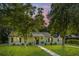 Charming single-story home with mature trees and a well-manicured front lawn at 318 Hollywood Dr, Charleston, SC 29407