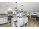 Open concept kitchen with a granite island, stainless steel appliances, and hardwood flooring throughout at 318 Hollywood Dr, Charleston, SC 29407