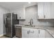 Modern kitchen featuring granite countertops, stainless steel appliances, a subway tile backsplash, and ample cabinet space at 318 Hollywood Dr, Charleston, SC 29407