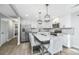 Bright kitchen with a granite island, stainless steel appliances, white cabinets, and stylish pendant lighting at 318 Hollywood Dr, Charleston, SC 29407