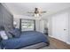 Cozy main bedroom with natural light, hardwood floors, gray walls, and an en-suite bathroom with a barn door at 318 Hollywood Dr, Charleston, SC 29407