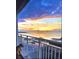 Balcony view of a colorful sunrise over the harbor with boats docked, as seen with dog at 330 Concord St # 7 A, Charleston, SC 29401