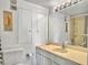 Bathroom featuring a toilet, sink, mirror, shower, and unique wall art at 330 Concord St # 7 A, Charleston, SC 29401