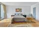 Bedroom with bed, colorful artwork, rug, and access to outdoor balcony at 330 Concord St # 7 A, Charleston, SC 29401