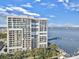 A waterfront condo building with balconies and views of the Ravenel Bridge in the distance on a partly cloudy day at 330 Concord St # 7 A, Charleston, SC 29401