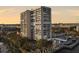 Condo building with balconies and a view of the city and waterfront, surrounded by trees at 330 Concord St # 7 A, Charleston, SC 29401