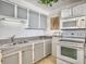 Traditional kitchen featuring granite countertops, grey cabinets, and white appliances at 330 Concord St # 7 A, Charleston, SC 29401