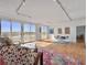 Open living room with hardwood floors, comfortable seating, track lighting, and access to the balcony at 330 Concord St # 7 A, Charleston, SC 29401