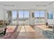 Light-filled living room featuring hardwood floors, seating area, and floor-to-ceiling sliding glass doors to the balcony at 330 Concord St # 7 A, Charleston, SC 29401