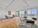 Bright living room with hardwood floors, track lighting, seating area, and sliding glass doors to a balcony with a view at 330 Concord St # 7 A, Charleston, SC 29401