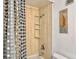 Shower equipped with a shower head, faucet, shower caddy, and patterned shower curtain at 330 Concord St # 7 A, Charleston, SC 29401
