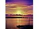A sunset view of the harbor with boats docked, seen from condo at 330 Concord St # 7 A, Charleston, SC 29401