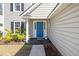 Welcoming front entrance with a bright blue door, decorative plants, and a 'Welcome' mat at 350 Arlington Dr, Charleston, SC 29414