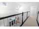 Second floor hallway overlooks a Gathering room featuring a fireplace and skylights at 350 Arlington Dr, Charleston, SC 29414