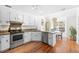 Bright kitchen featuring stainless steel appliances, white cabinets, and an adjacent dining area with natural light at 350 Arlington Dr, Charleston, SC 29414