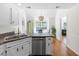 A kitchen with stainless steel appliances, white cabinets, wood floors, and plenty of counter space at 350 Arlington Dr, Charleston, SC 29414