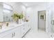 Elegant bathroom features double vanity, marble countertops, gold fixtures and glass enclosed shower at 351 Claret Cup Way, Charleston, SC 29414
