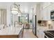 Bright kitchen with island seating, stainless steel appliances, and pendant lighting at 351 Claret Cup Way, Charleston, SC 29414